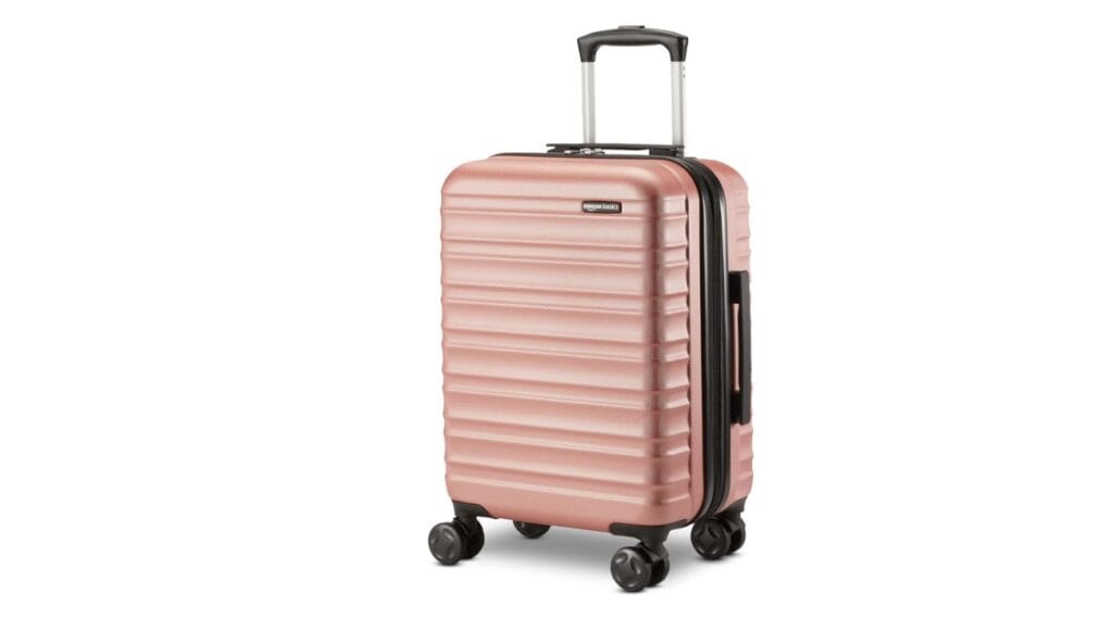 Amazon Basics 21-inch hard shell expandable carry-on suitcase in black with scratch-resistant surface and multi-directional wheels.